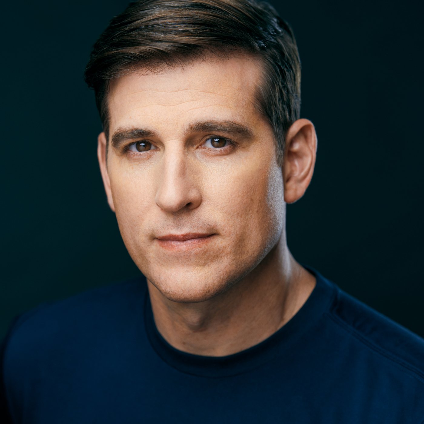 Jonathan Chase Greenfield looking directly at the camera against a dark background